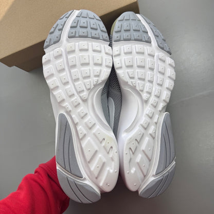 Nike running shoes grey mesh upper with white sole and logo detail.