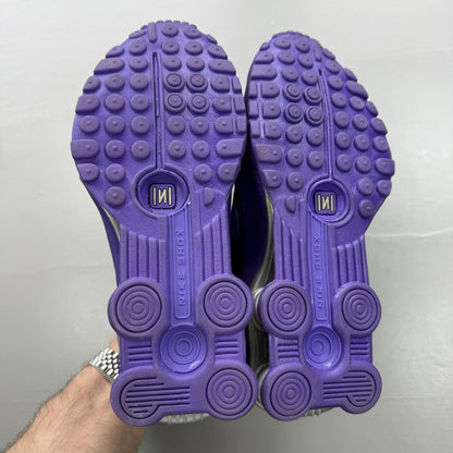 Nike trainers purple with silver accents and distinctive Shox cushioning system.