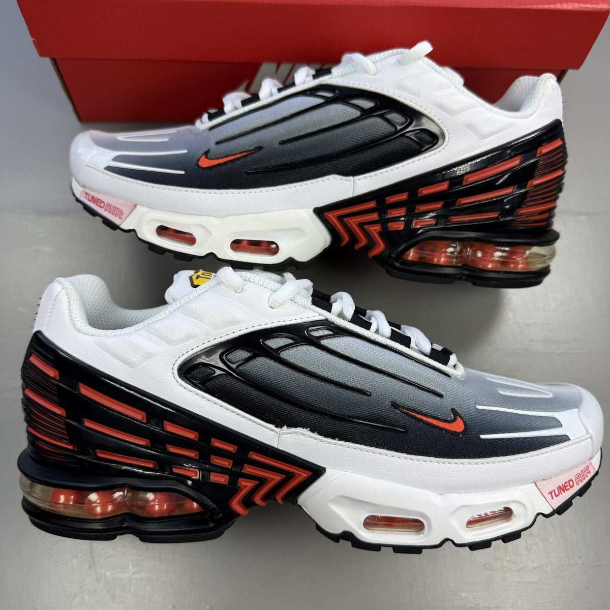 Nike Air Max Plus TN 3 white trainers with black and team orange accents, logo detail.