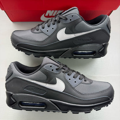 Nike Air Max 90 black sneakers with reflective silver accents and logo.