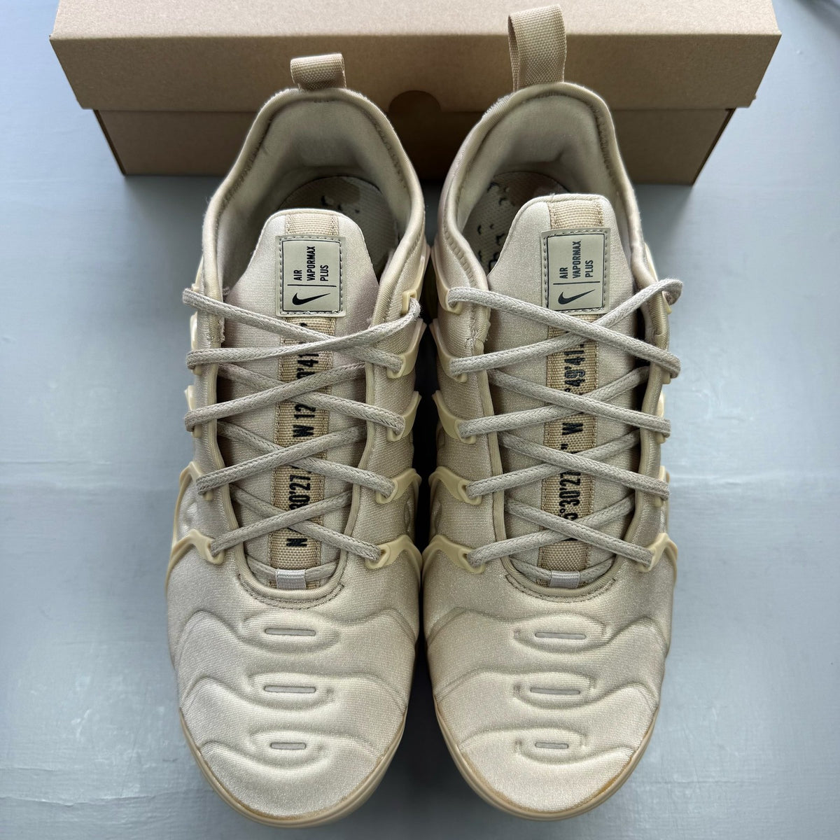 Nike Air VaporMax Plus trainers brown with mesh upper and signature swoosh logo.