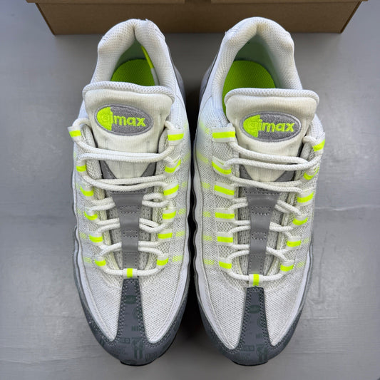 Nike trainers white with neon grey volt accents and retro logo detailing.
