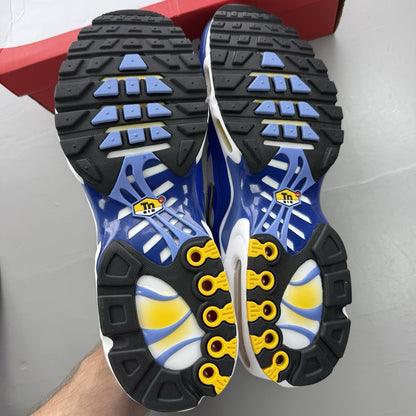 Nike Air Max Plus TN white trainers with blue and yellow accents, mesh upper.