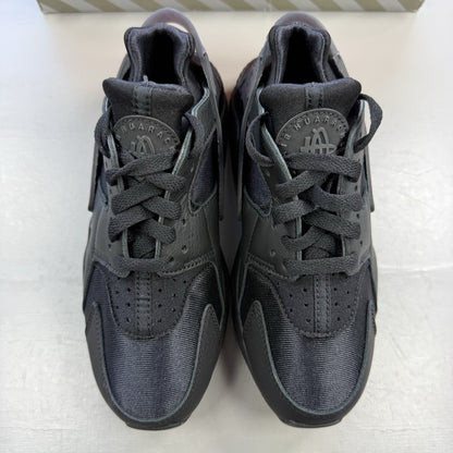 Nike black Air Huarache trainers with anthracite heel tab and distinctive design.