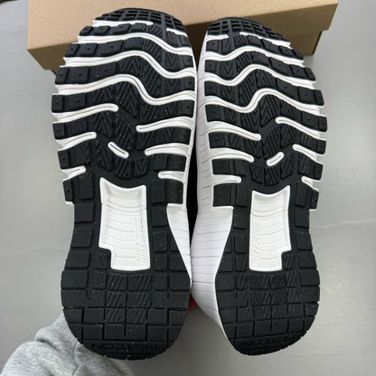 Nike black trainers with white accents and breathable mesh upper.