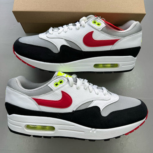 Nike trainers white with chili volt and red accents, featuring iconic swoosh logo.