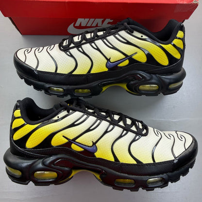 Nike black Air Max Plus TN trainers with bright citron accents and logo detail.