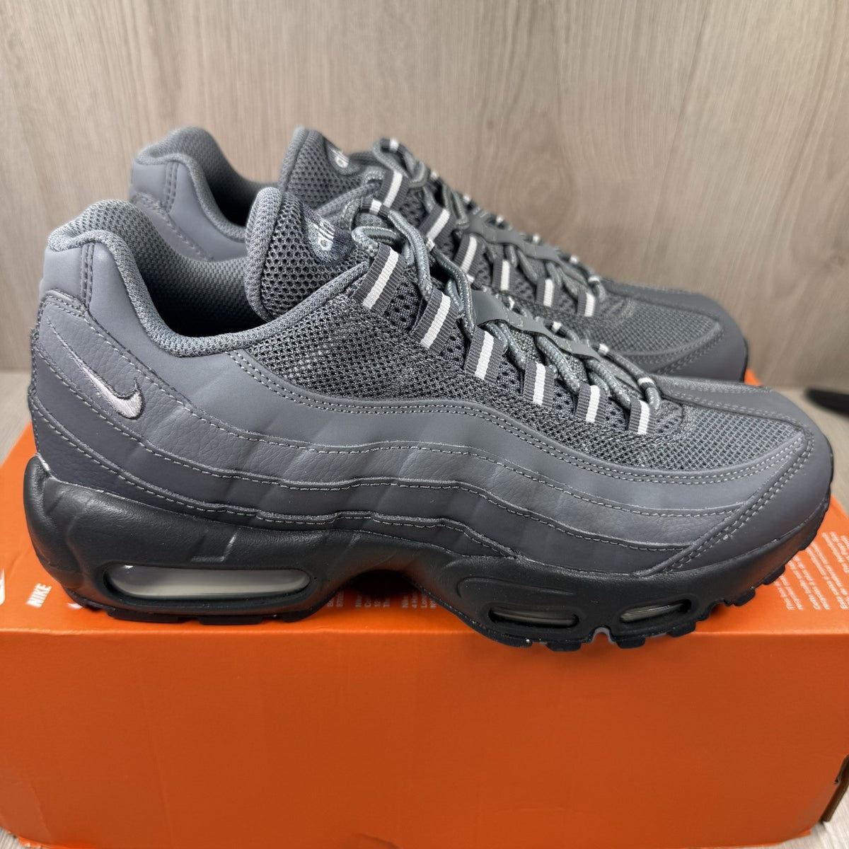 Nike Air Max 95 trainers grey with black accents and textured material.