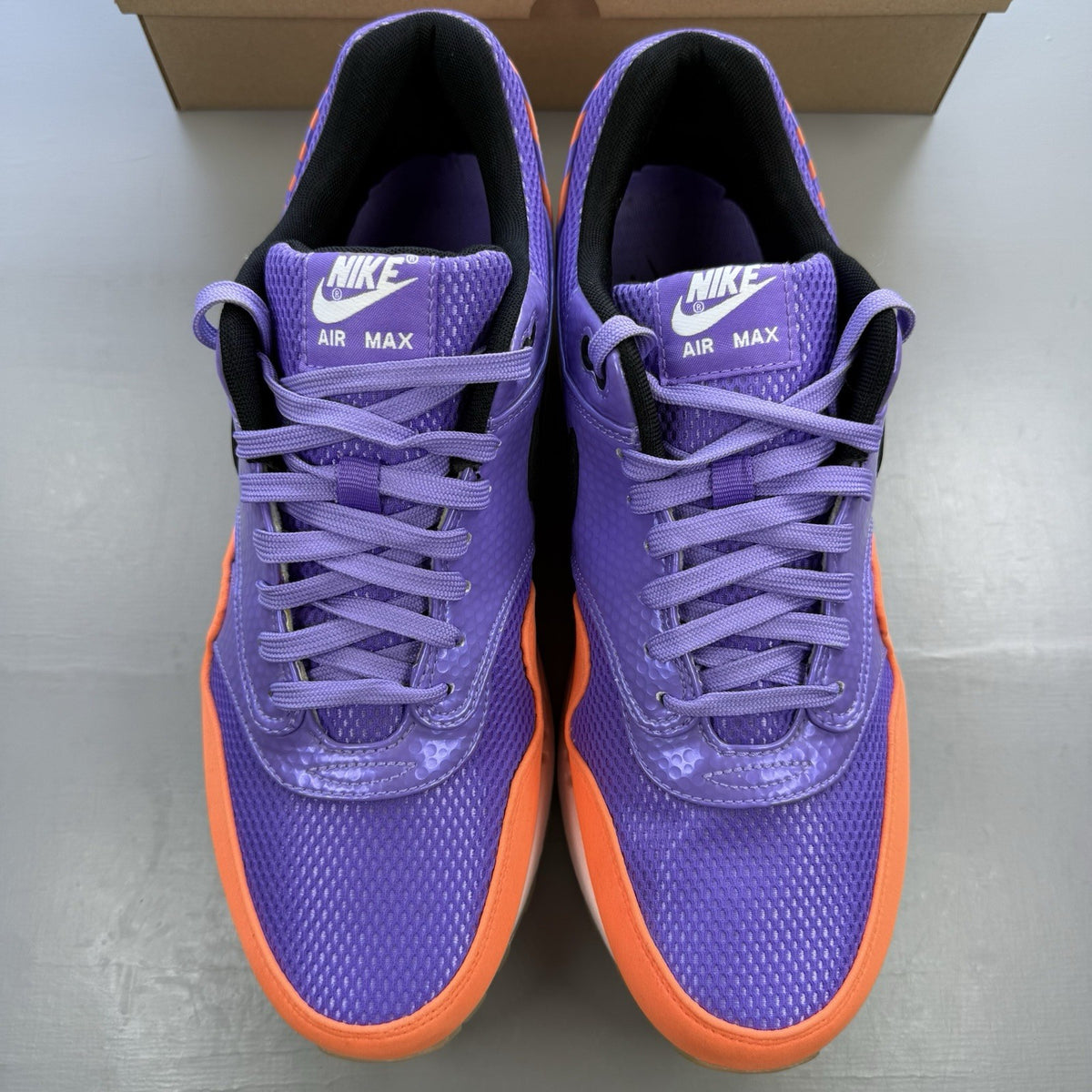 Nike Air Max 1 white trainers with atomic violet and orange accents, 100% authentic.