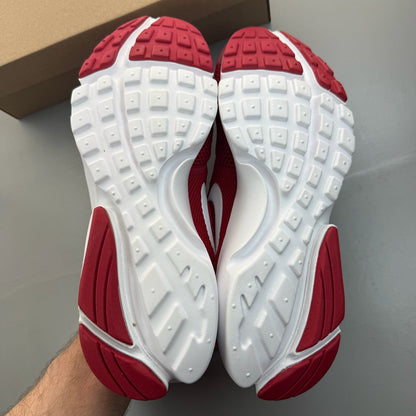 Nike Presto Fly red trainers with white accents and logo detail.