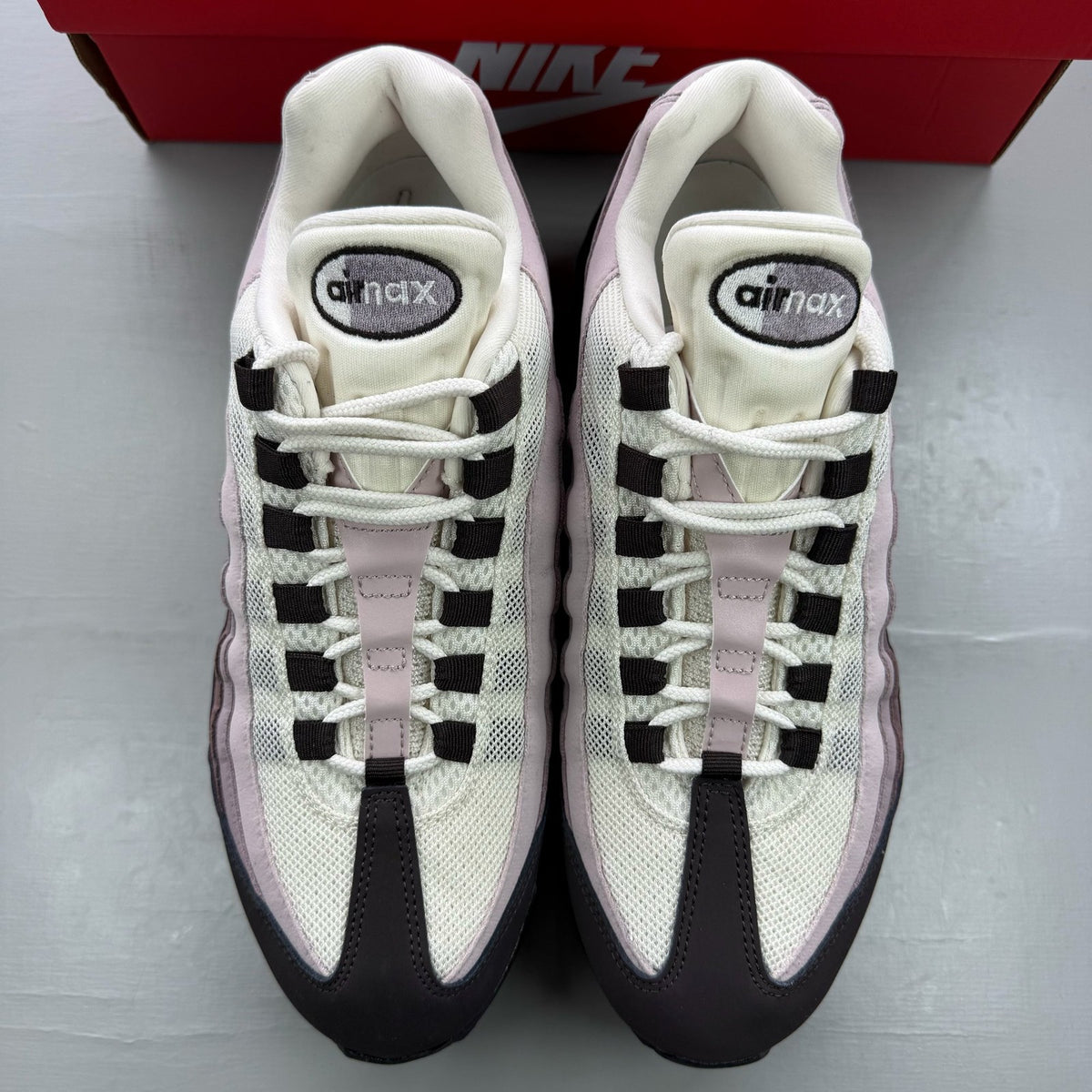 Nike Air Max 95 black trainers with light velvet brown accents and logo detail.