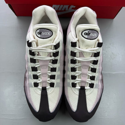Nike Air Max 95 black trainers with light velvet brown accents and logo detail.