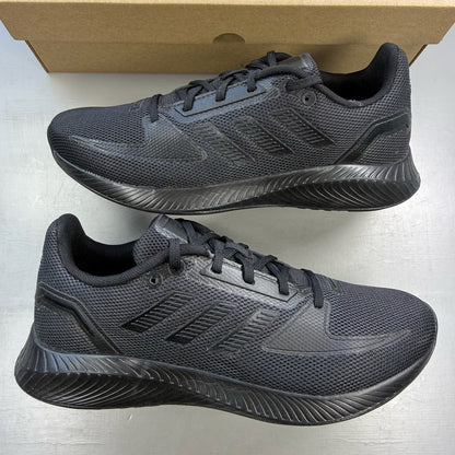 Adidas black trainers with signature three stripes and cushioned sole.