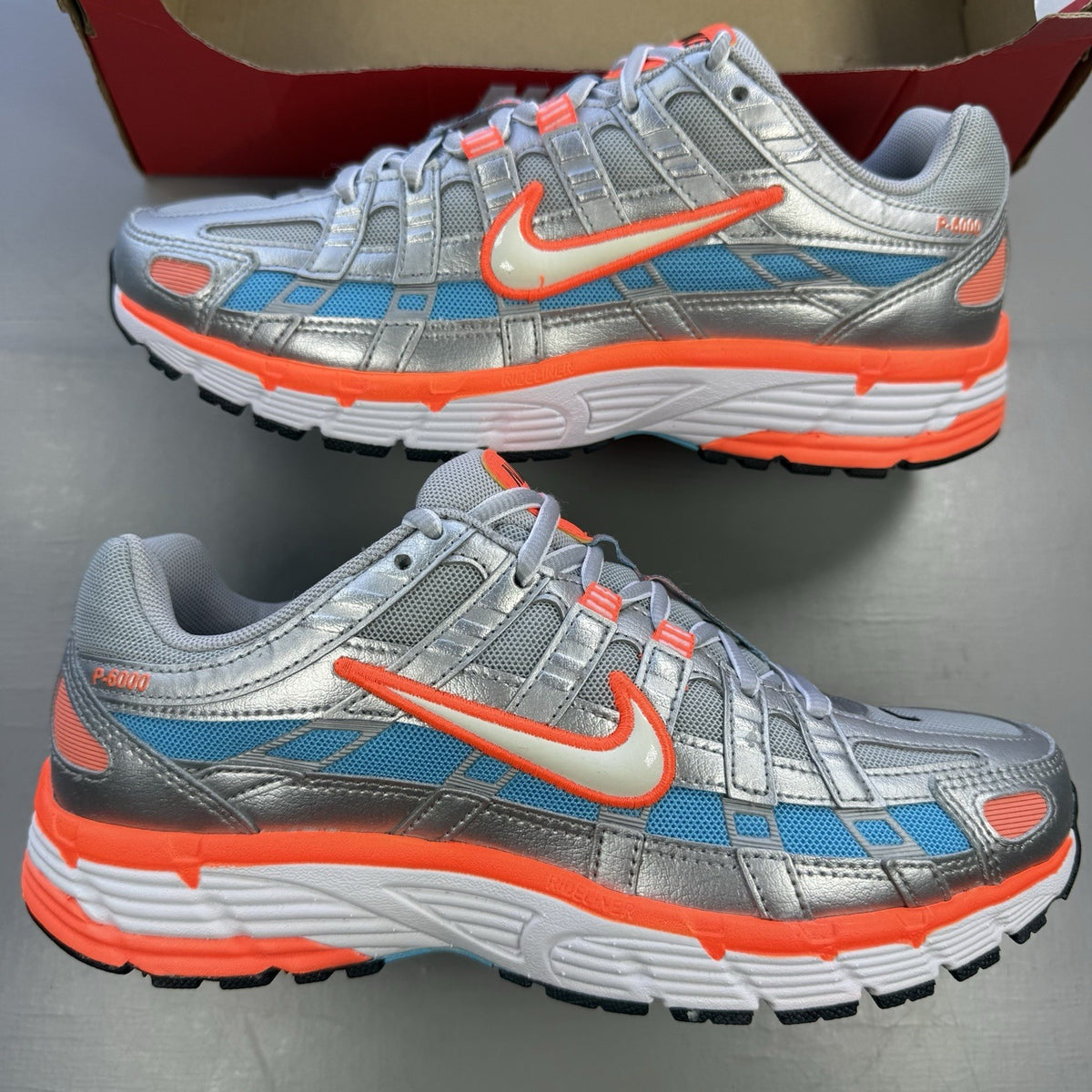 Nike P-6000 grey trainers with metallic accents and crimson blue fury details.