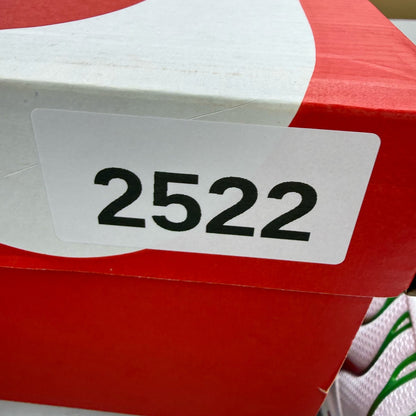 Nike Air Max Plus TN white trainers with green and red accents, featuring iconic logo.