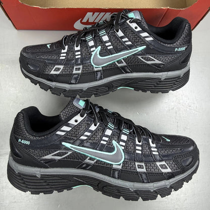 Nike black trainers with Cool Grey and Hyper Turquoise accents, featuring a sleek design.