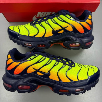 Nike yellow trainers with Hyper Crimson accents and distinctive Air Max Plus design.