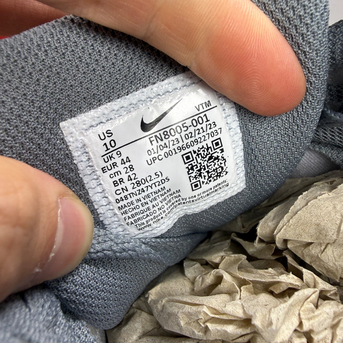 Nike athletic shoes grey with blue accents and Air Max logo detail.