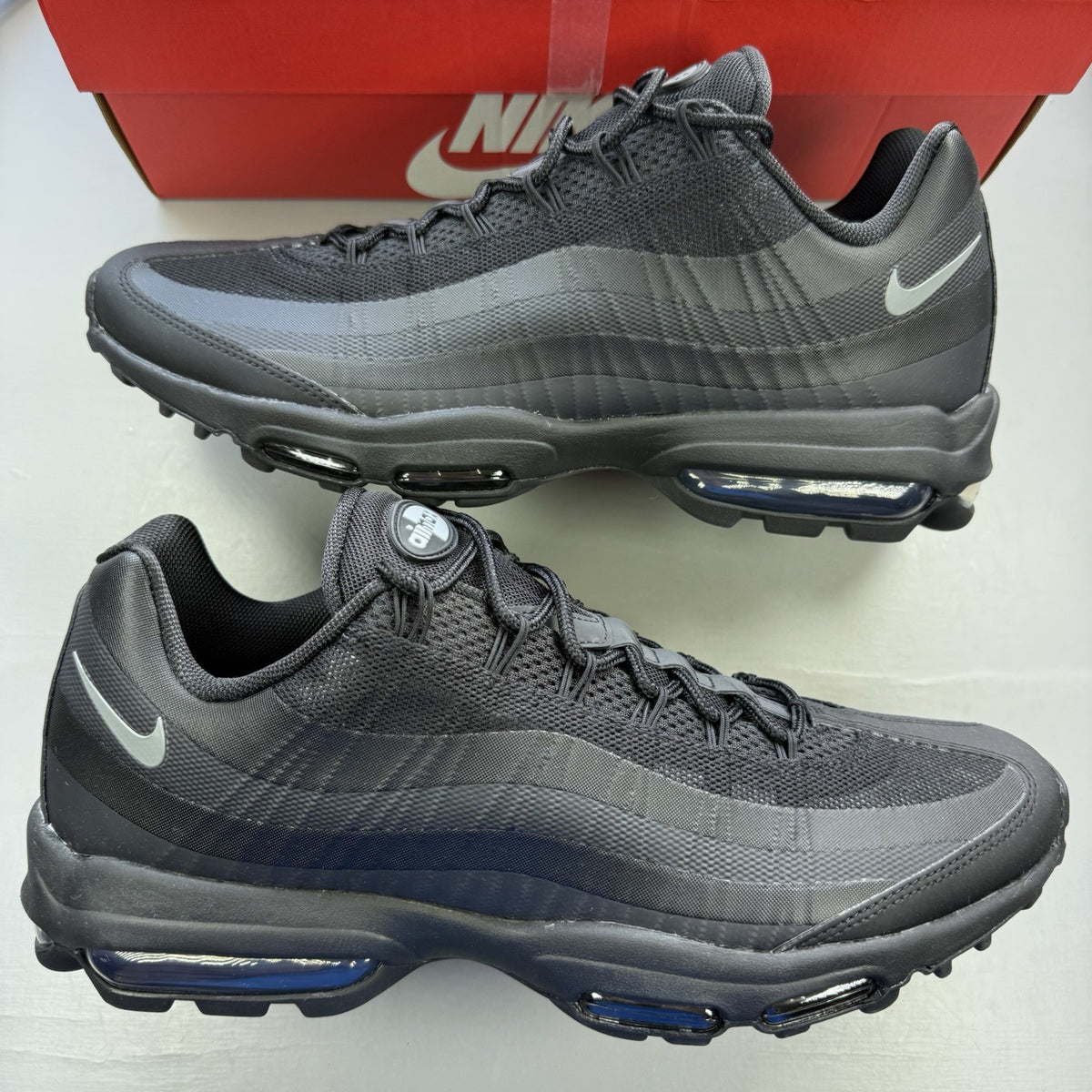 Nike Air Max 95 Ultra black trainers with grey accents and signature logo details.