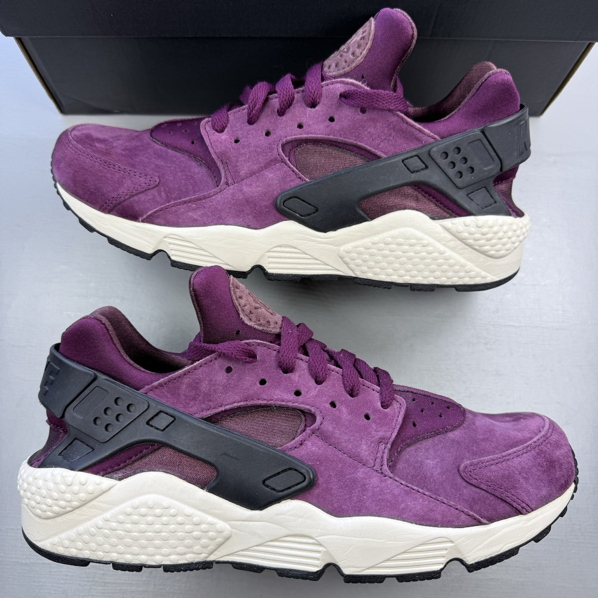 Nike Air Huarache trainers in purple with light bone accents and white sole.