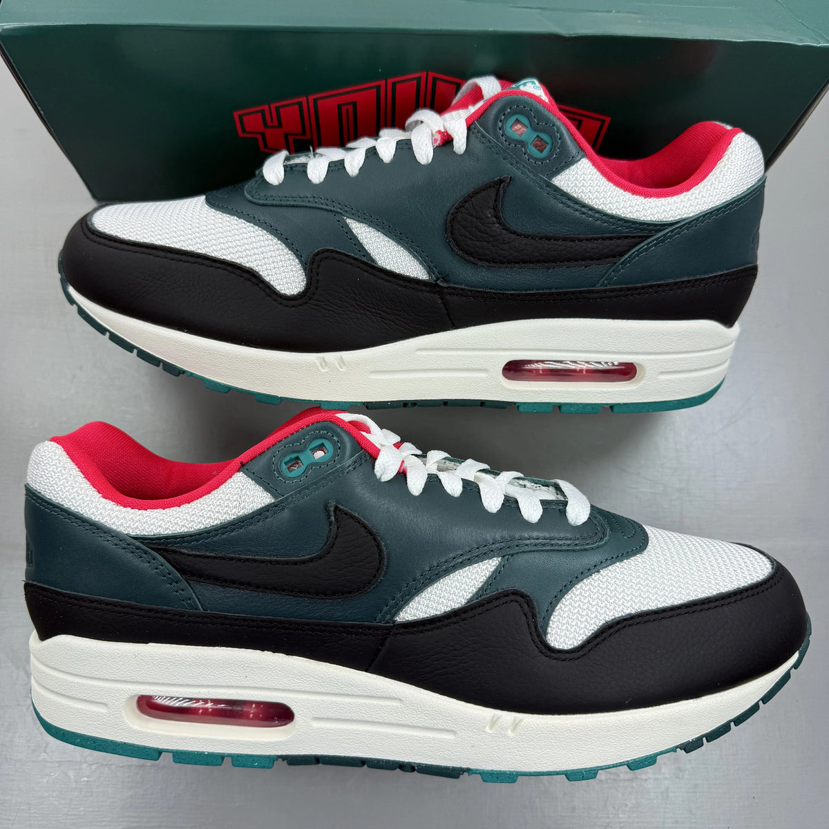 Nike Air Max 1 white trainers with LeBron James logo and Liverpool FC details.