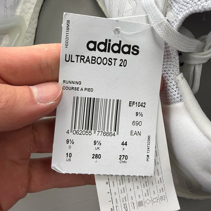 Adidas Ultra Boost 20 white running trainers with mesh upper and signature three stripes.