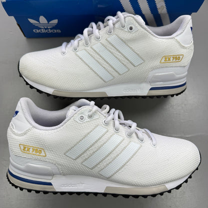 Adidas white trainers with blue accents and woven texture, featuring iconic logo.