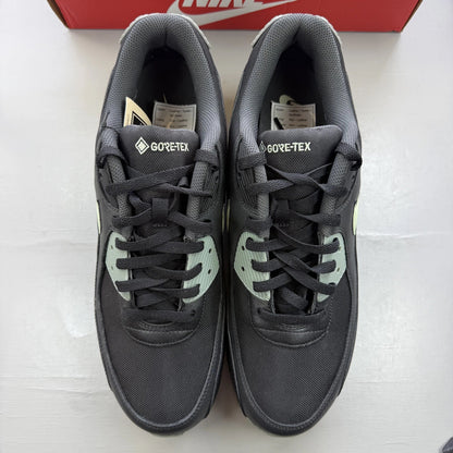 Nike Air Max 90 black trainers with Gore-Tex material and honeydew accents.