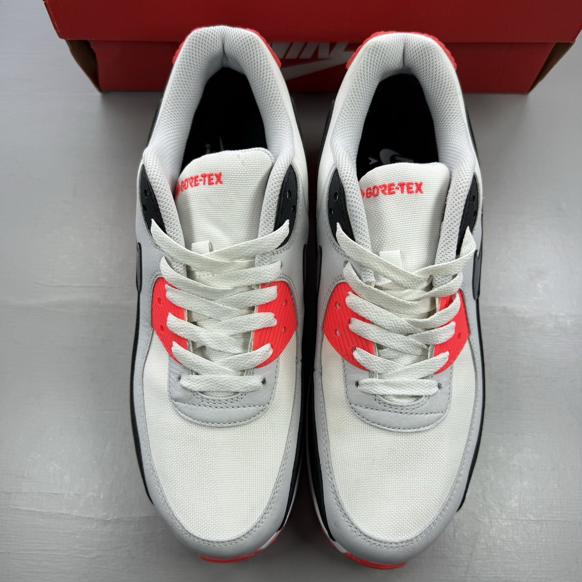 Nike Air Max 90 trainers white Gore-Tex with infrared accents and logo detail.