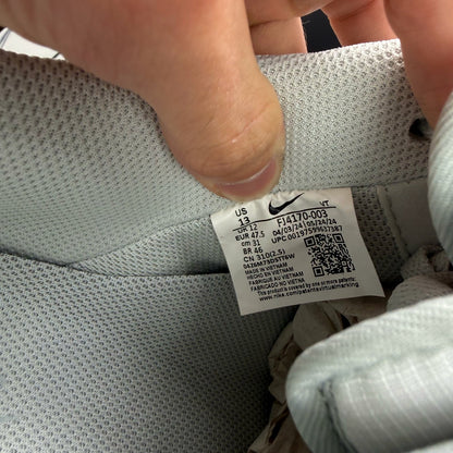 Nike Air Force 1 grey low-top sneakers with light silver accents and white sole.