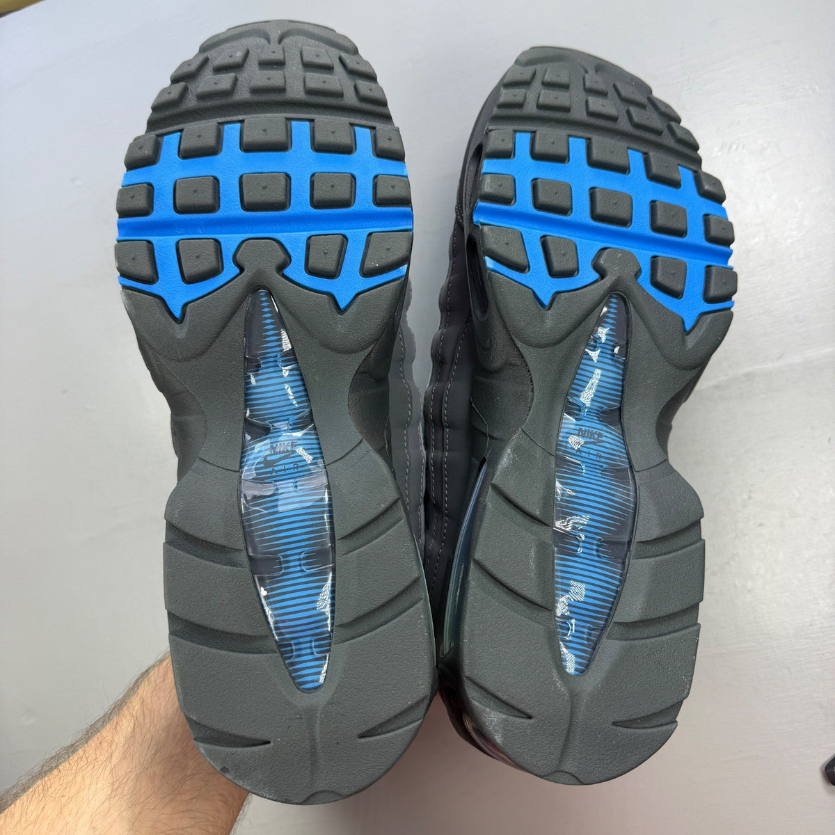 Nike Air Max 95 green trainers with big bubble design and blue accents.
