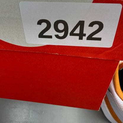 Nike Air Max 1 white trainers with Monarch orange and black accents, featuring logo details.