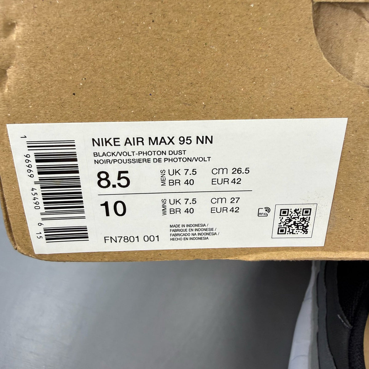 Nike Air Max 95 black trainers with grey and white accents, featuring iconic logo details.