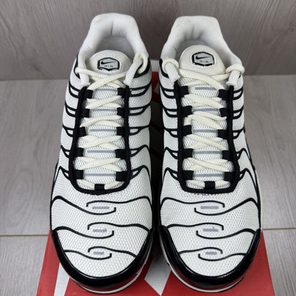 Nike Air Max Plus TN ESS trainers white with black accents and signature swoosh logo.