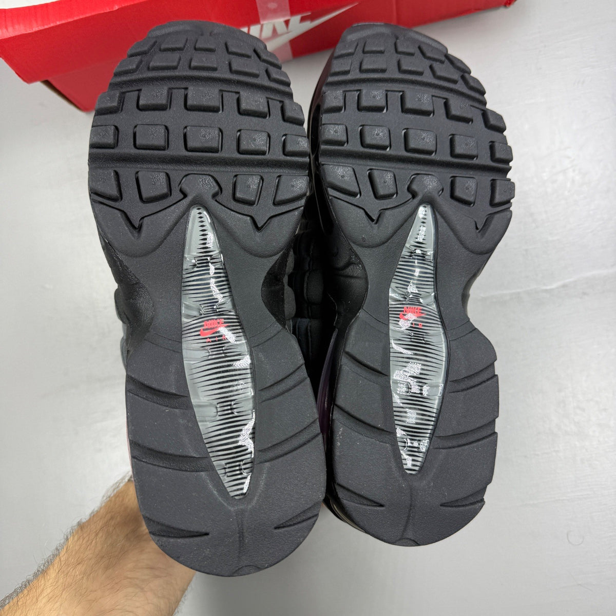 Nike deck shoes black with bright crimson accents and signature logo details.