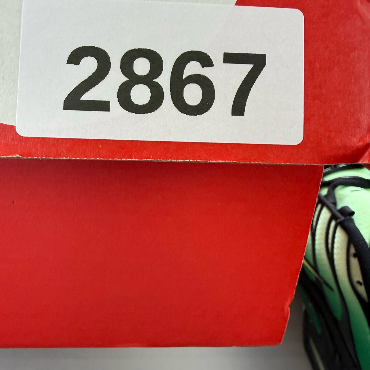 Nike Air Max Plus TN green trainers with lemon twist accents and distinctive logo.