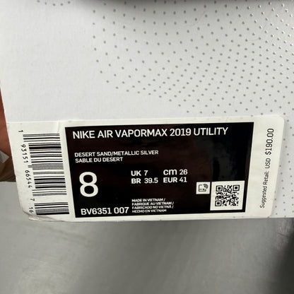 Nike running shoes beige with Air VaporMax sole and utility design.