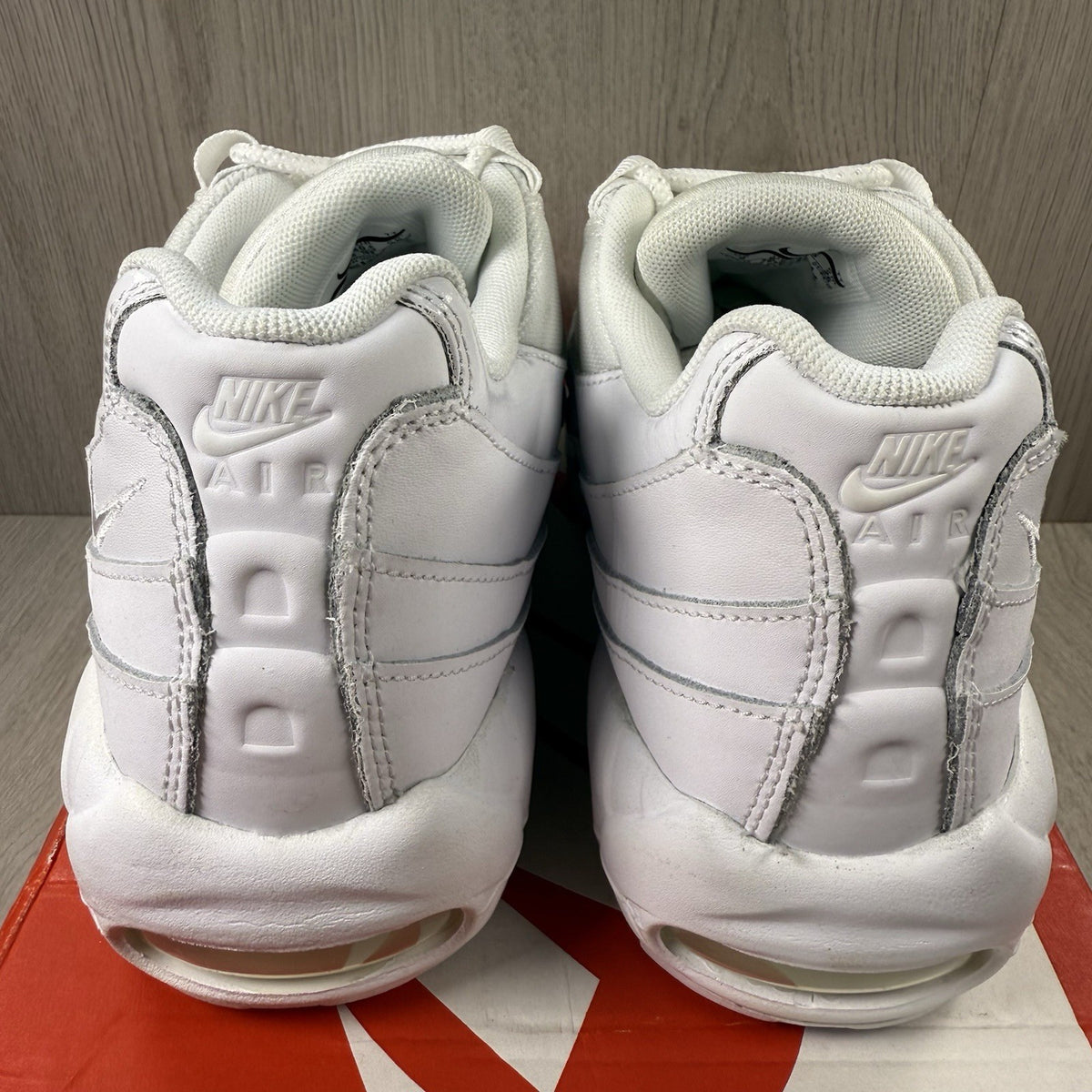 Nike Air Max 95 trainers white mesh upper with signature swoosh logo and reflective details.