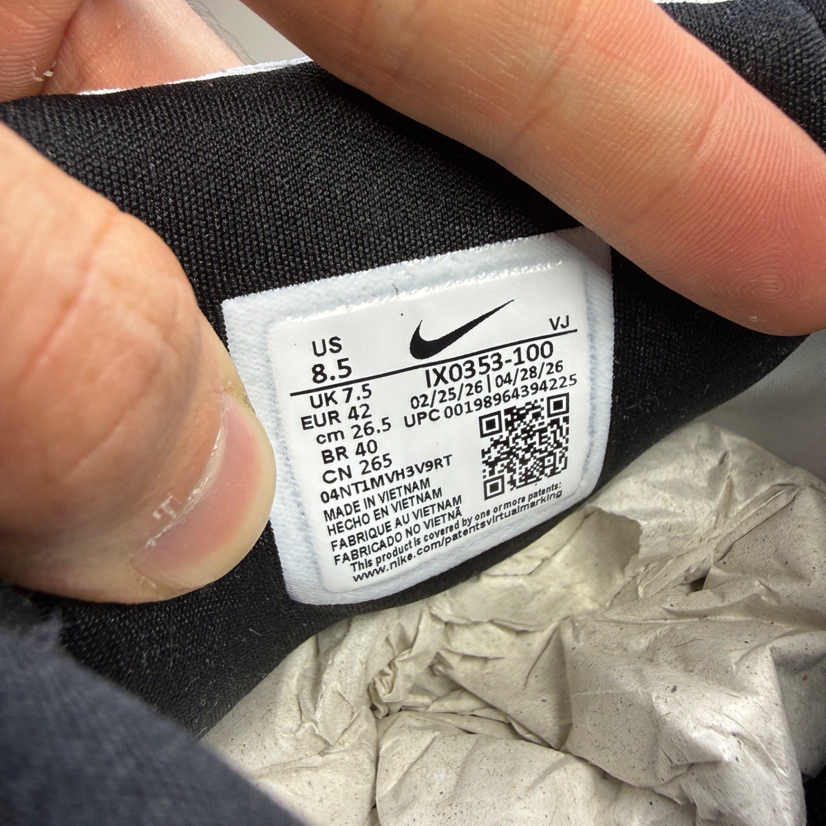 Nike white trainers with light armoury blue and black accents, featuring logo details.