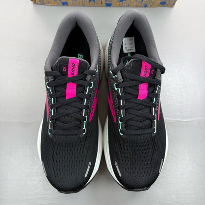 Brooks black trainers with white and pink accents, featuring logo and breathable mesh material.