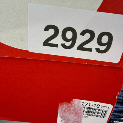 Nike Air Max 97 blue trainers with red accents and iconic logo detailing.