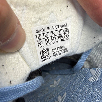 Adidas athletic shoes sky blue with white stripes and logo detail.