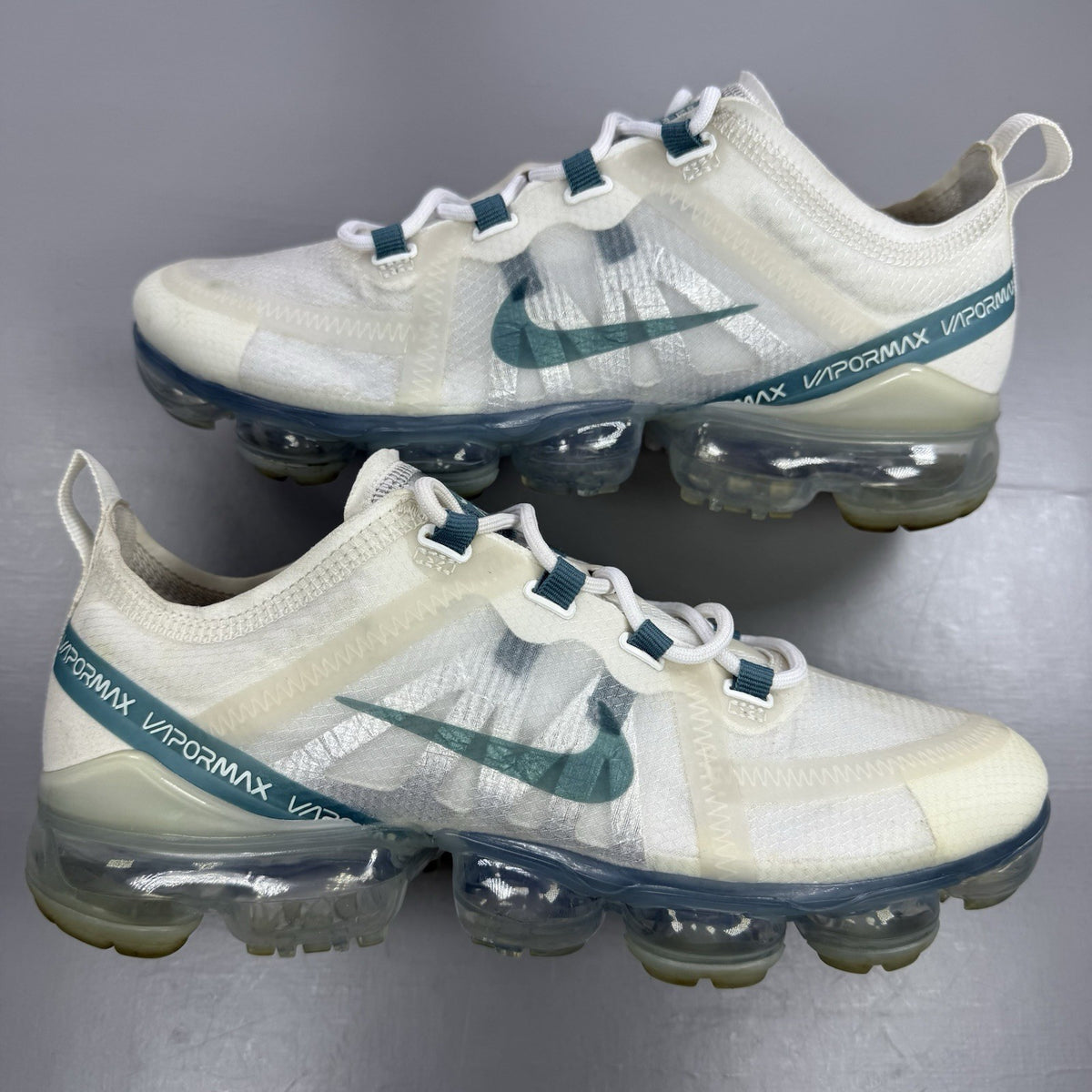 Nike Air VaporMax 2019 white trainers with mineral teal accents and transparent sole.