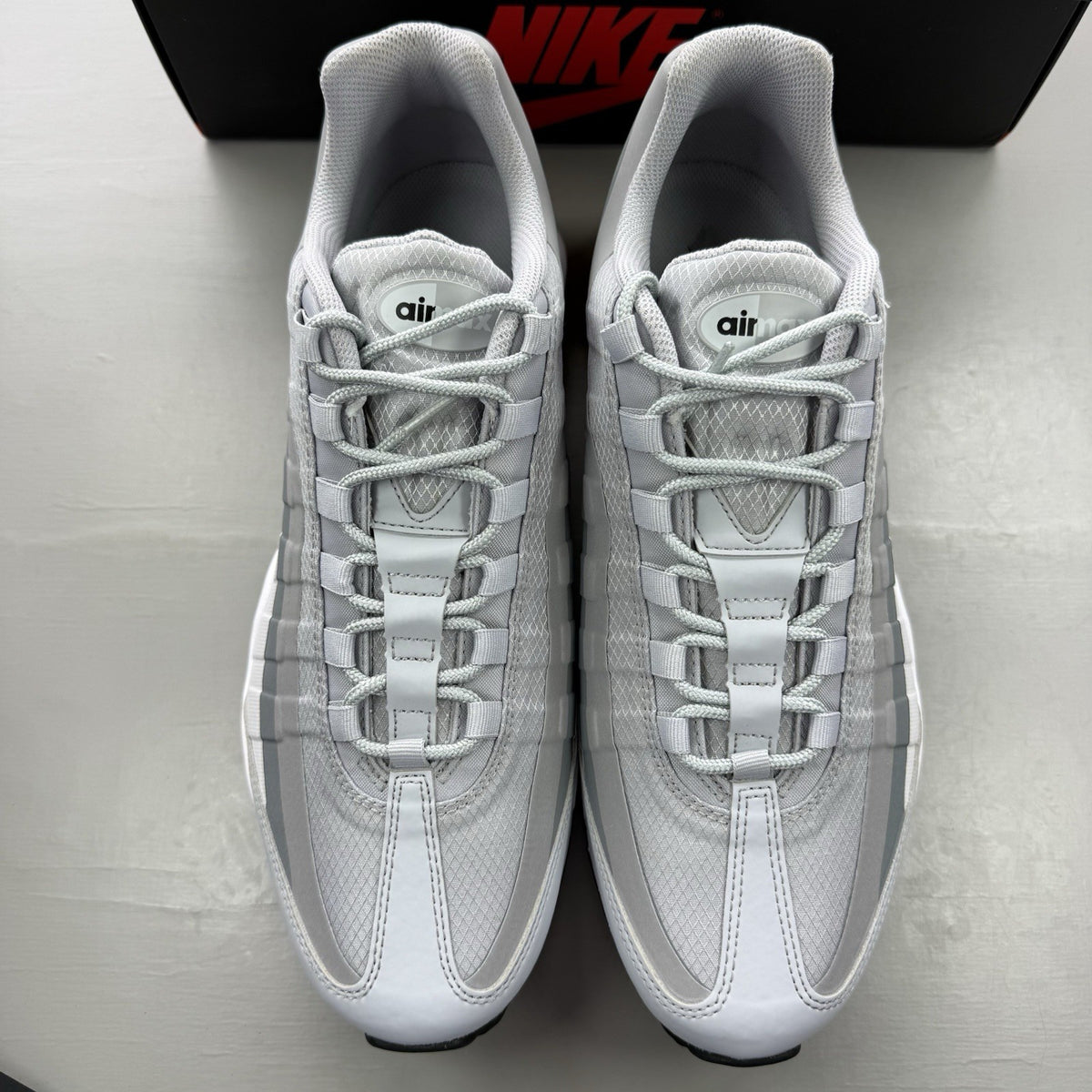 Nike Air Max 95 Ultra grey trainers with black and white accents, mesh and leather material.