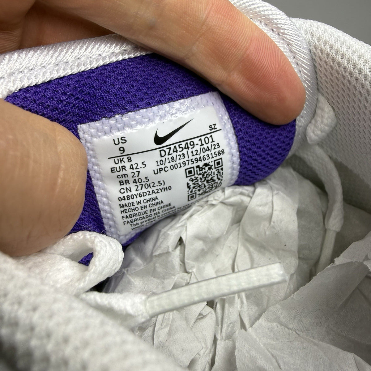 Nike Air Max 1 SC white trainers with purple and black accents, featuring logo detail.