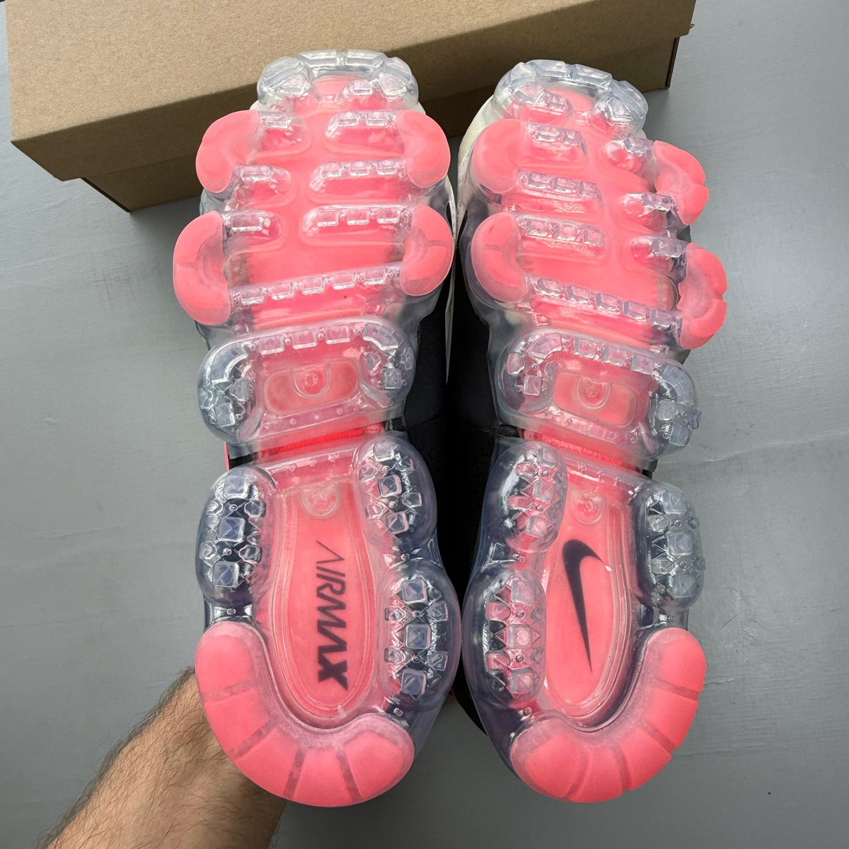 Nike Air VaporMax CS white trainers with mesh upper and vibrant Hot Punch accents.