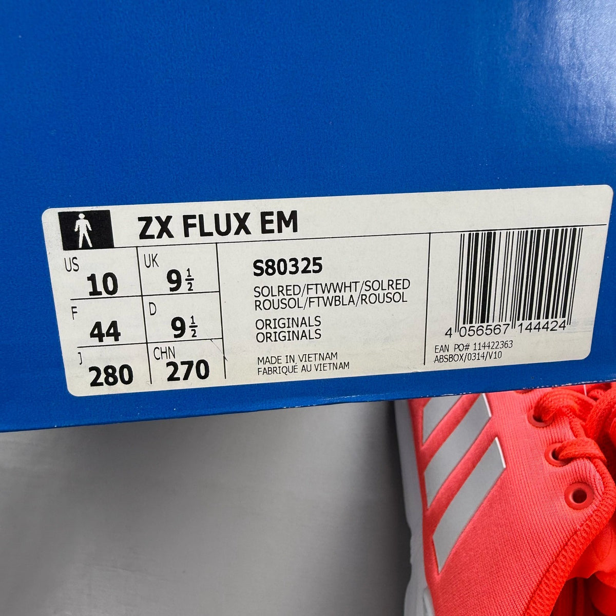 Adidas ZX Flux EM red trainers with white accents and textured mesh upper.