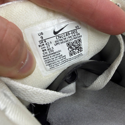 Nike athletic shoes metallic silver with mesh upper and reflective detailing.