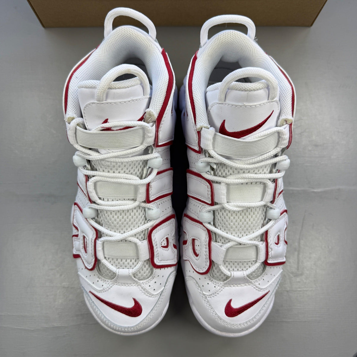 Nike athletic shoes white with varsity red accents and bold "AIR" lettering.