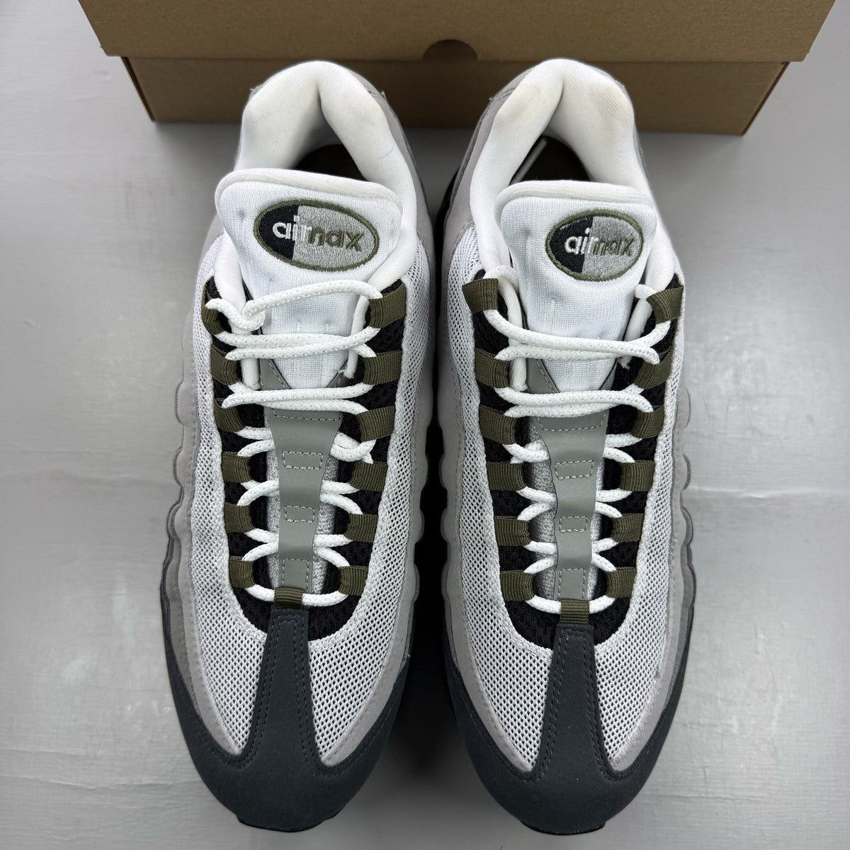 Nike Air Max 95 grey trainers with big bubble sole and logo detailing.